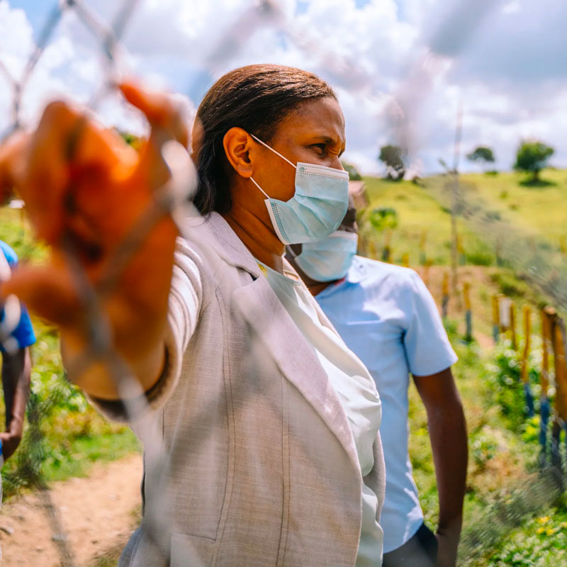 Female doctor talking to farm workers