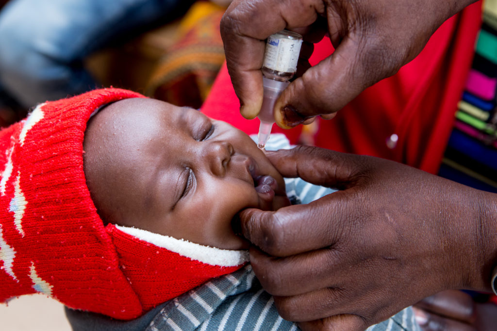 A nurse administers an oral poliovirus vaccine (OPV) to a baby at the Kaloko Clinic, Ndola, Copperbelt Province, Zambia